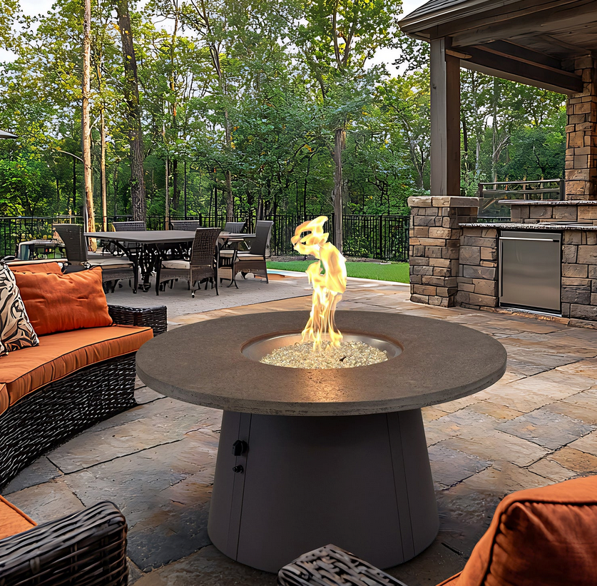 Outdoor-Gas-Fire-Table-—-Daphne,-AL Outdoor gas fire table on a stone patio with wicker seating and a built-in grill in Daphne, Alabama